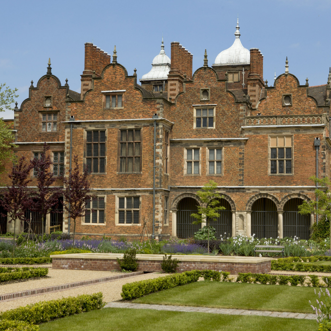 Large religious building with garden at the front.